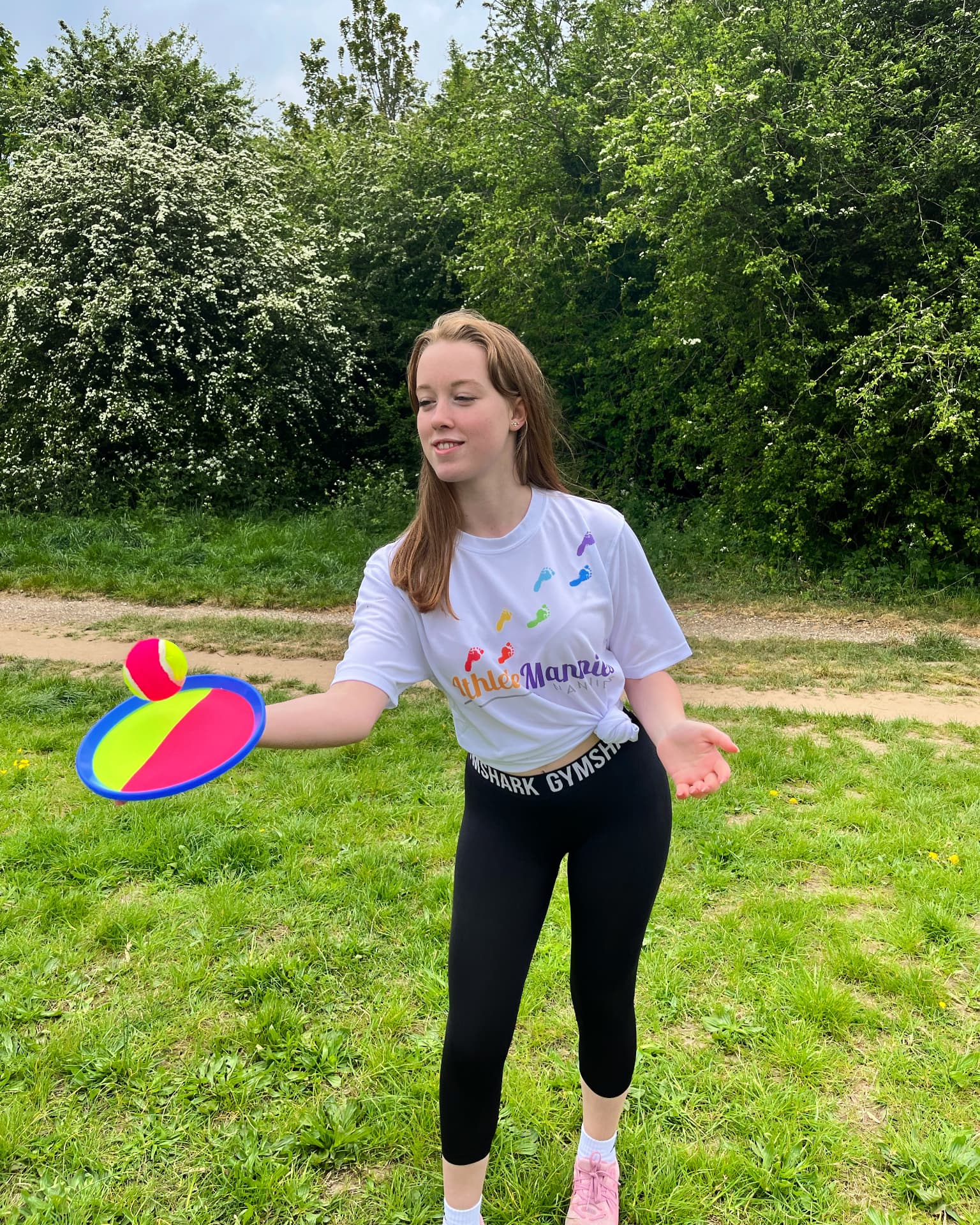 An Athlete Nannies carer playing catch outdoors with sports equipment